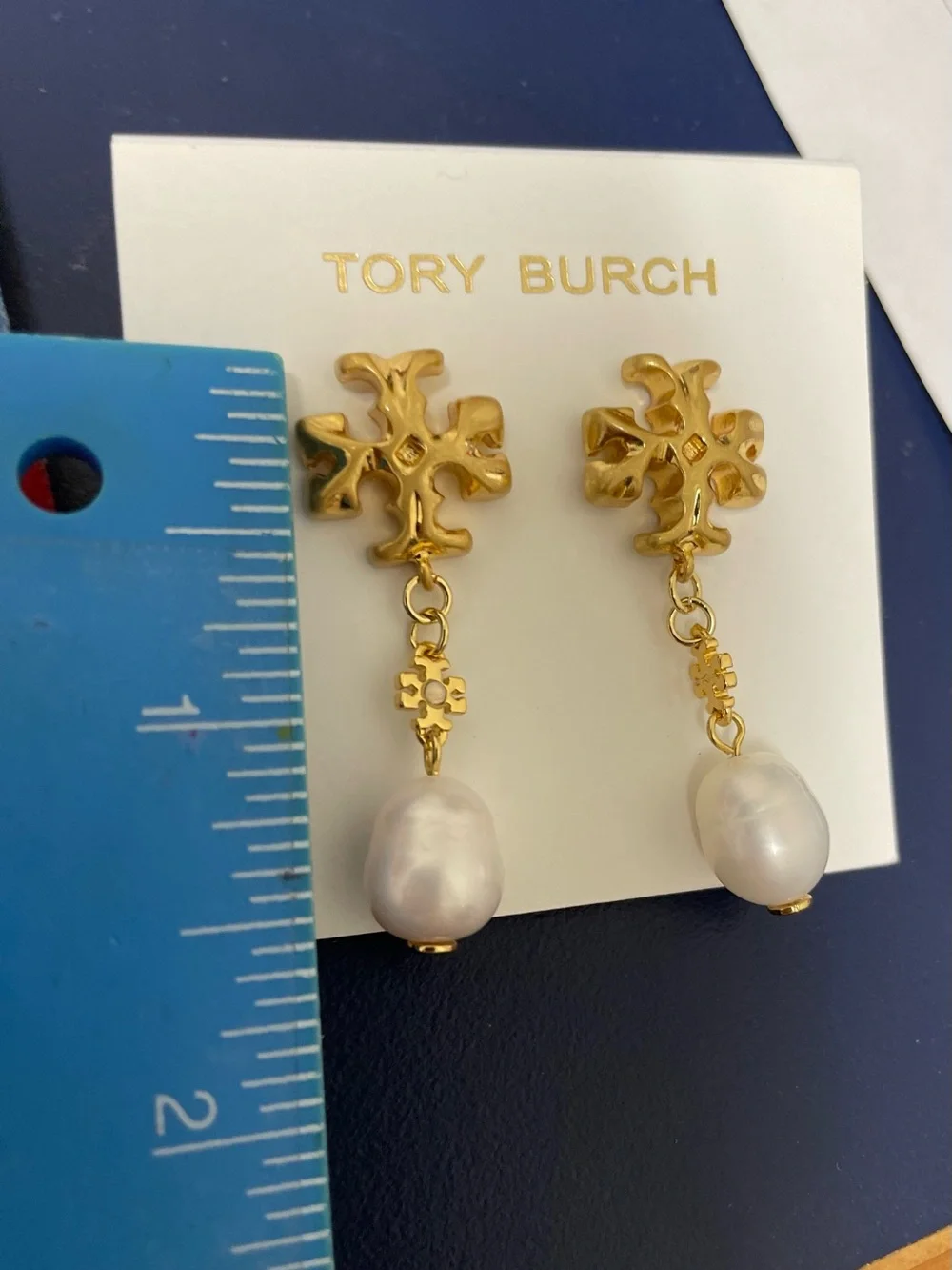Brand new pearl-drop earrings by Tory Burch.